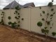 JUNIPERUS KAIZUKA TOPIARY BALLS -  these  beautiful topiary different specimens were planted  in a narrow garden,in front of a plain wall.This wall was very visible for guests arriving at the property,and  what a difference these plants made to the overall look ,no other plants were necessary ,because  all these topiary needed  was a setting that was very plain and simple to show them off to their best.