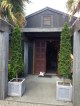 These topiary columns make a formal and effective look to this showroom entranceway.